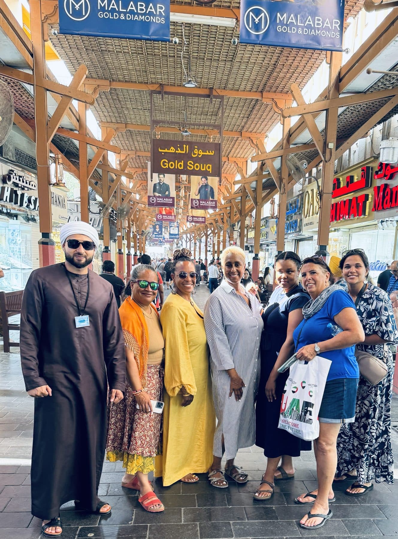 Muhammad Bilal with guests under the Gold Souq sign in Old Dubai