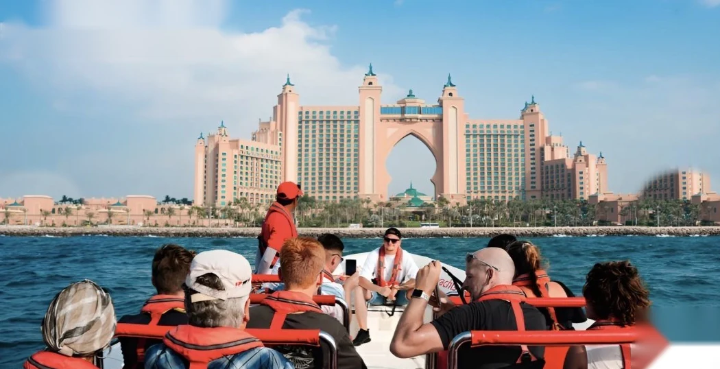 Guests in life jackets on a speedboat facing Atlantis The Palm